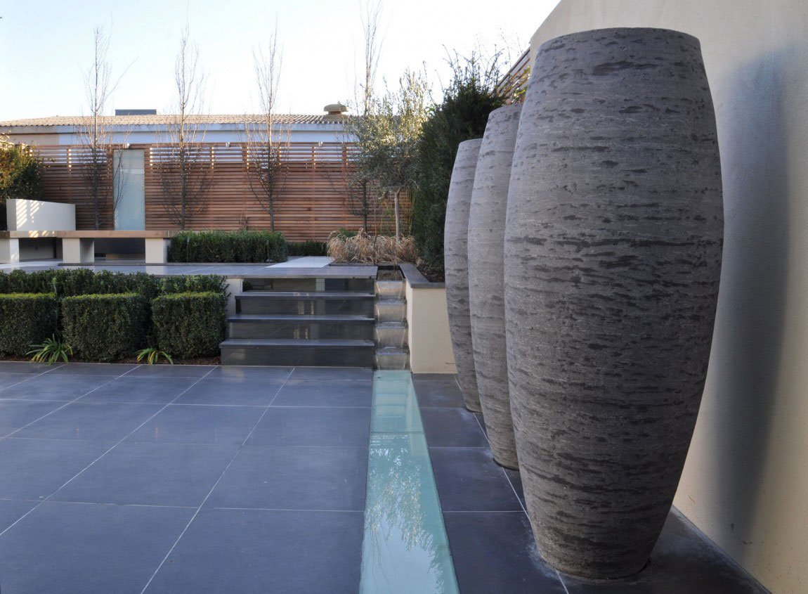 exterior-modern-outdoor-space-for-with-three-large-stone-jars-and-plant-with-black-tile-floor-fabulous-outdoor-design-ideas