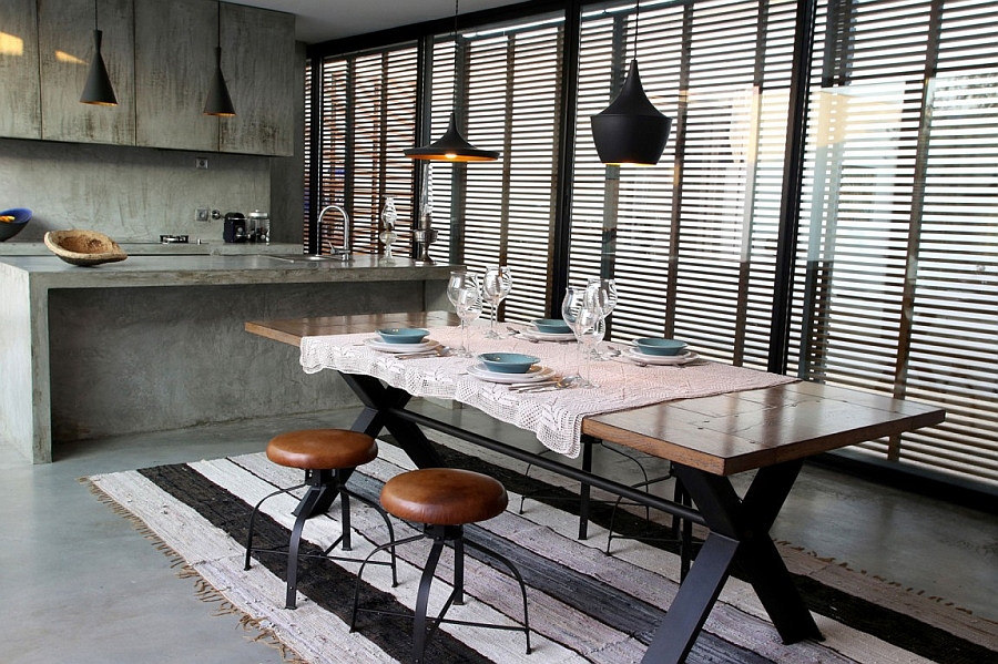 modern-industrial-styled-kitchen-with-dining-area-contains-wooden-dining-table-chic-stools-and-black-pendant-lights