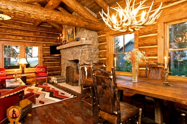 Rustic-living-room-design-stone-fireplace-wood-table-antler-chandelier