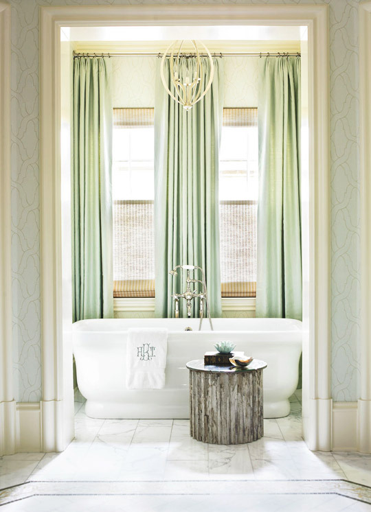 Stand alone master bath tub along with white marble flooring.