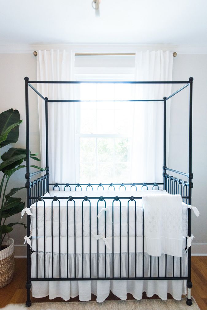 Neutral Baby Nursery with Black Iron Canopy Crib