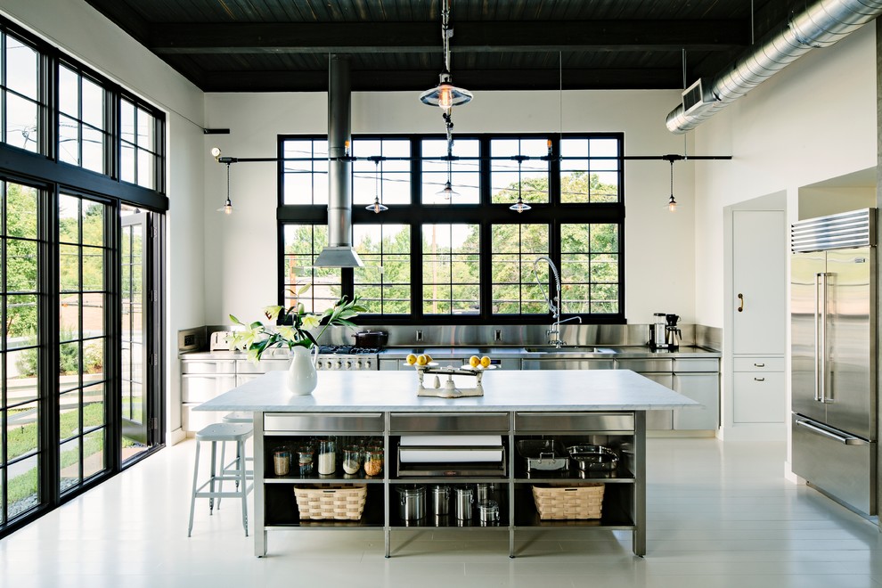 A machined hood, custom stainless cabinetry and exposed ducting